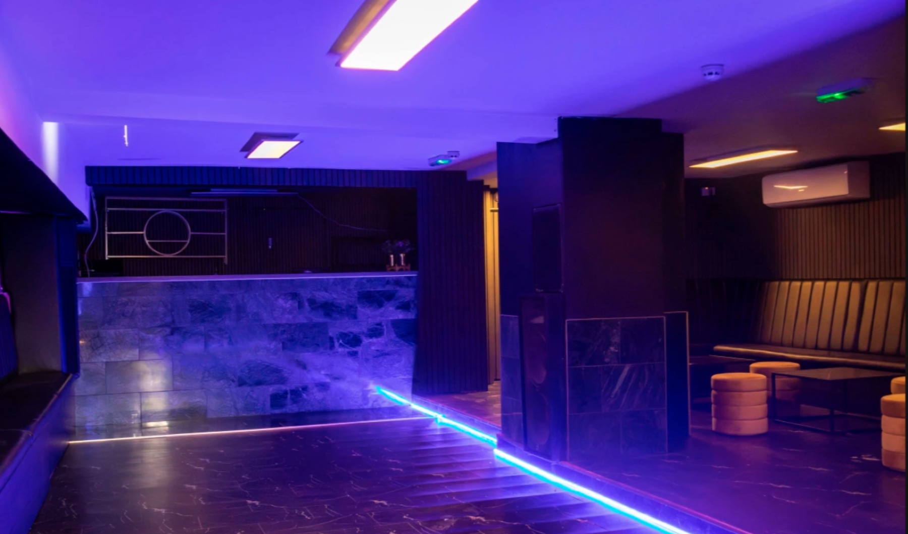 Modern nightclub interior under blue lighting