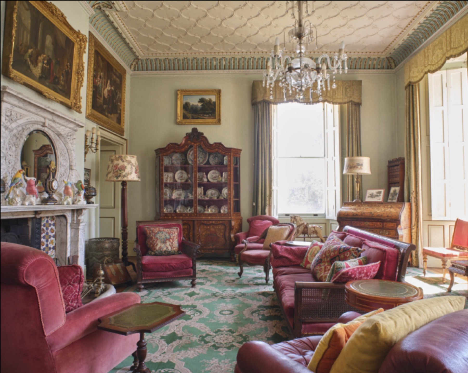 Period drawing room with fireplace and upholstered seating