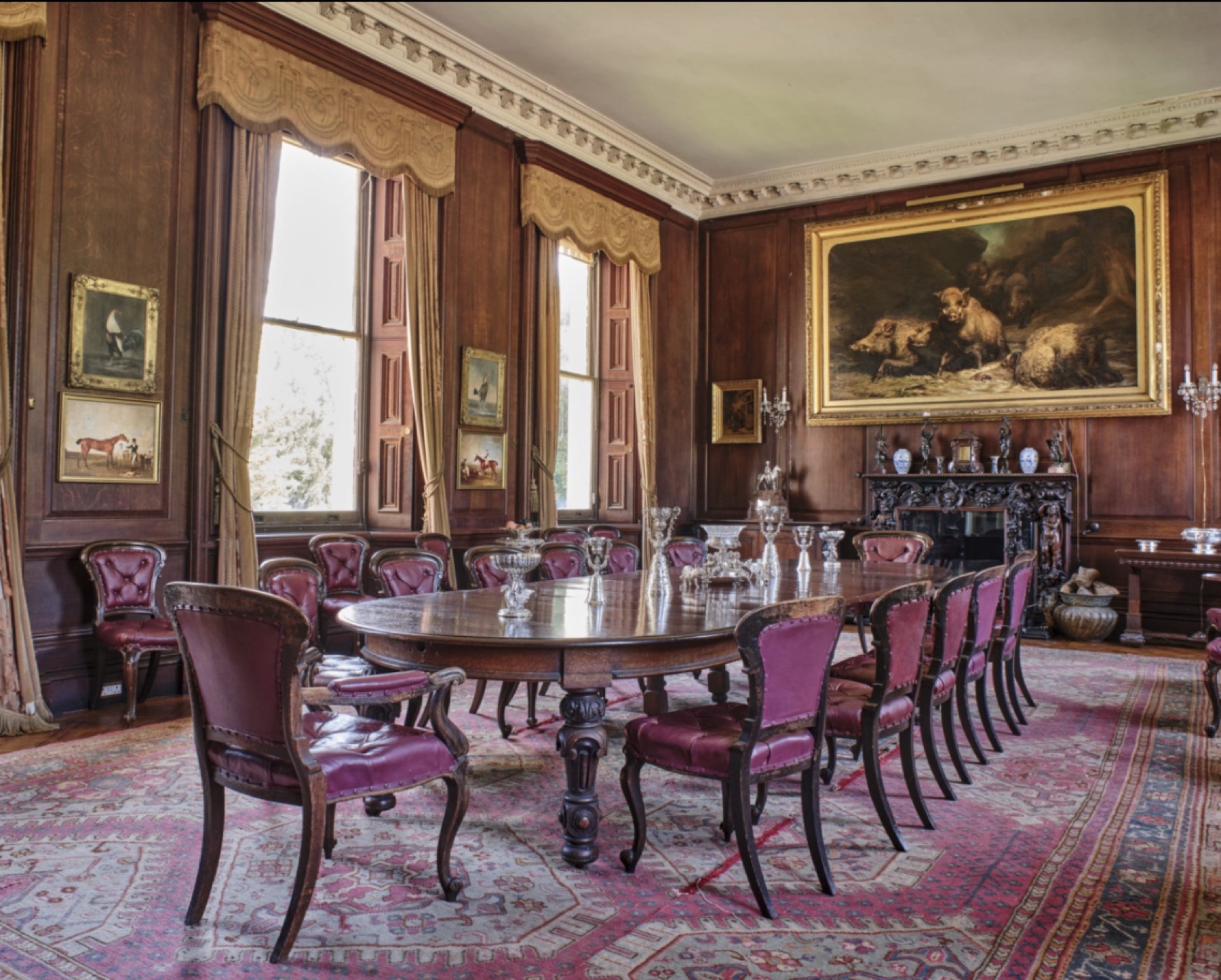 Formal dining room with portraits and a long table