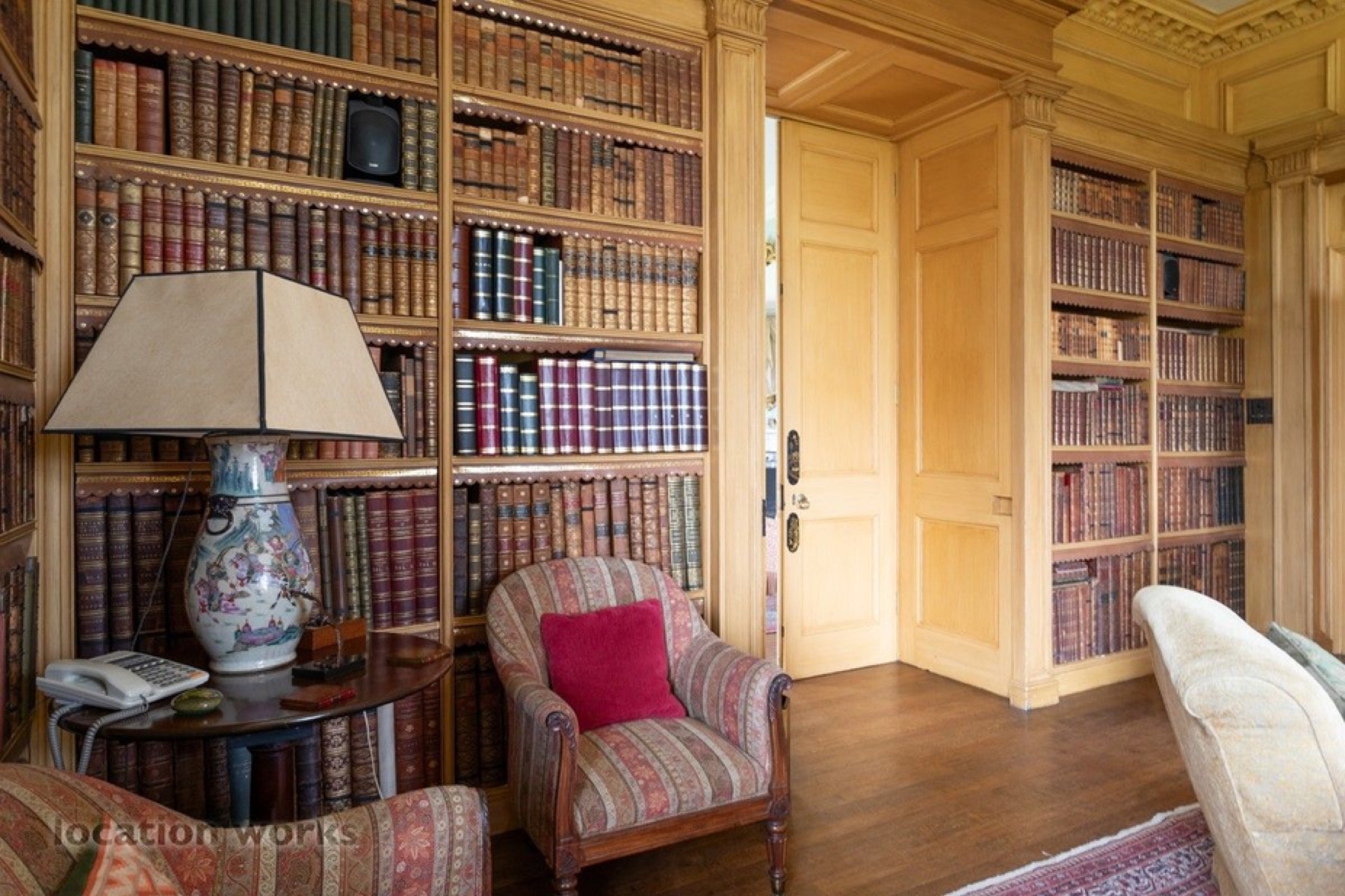 Warm library with built-in bookshelves and reading chair