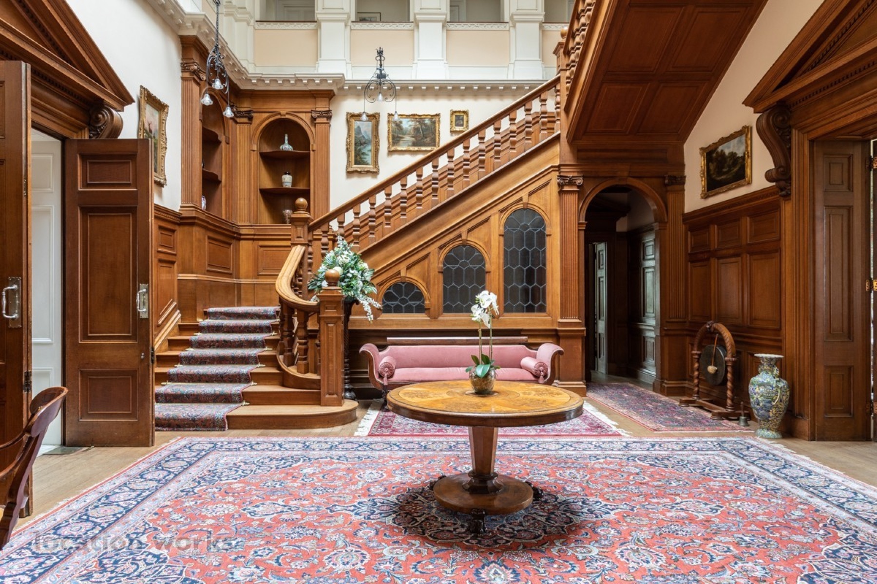 Grand timber staircase and central reception table
