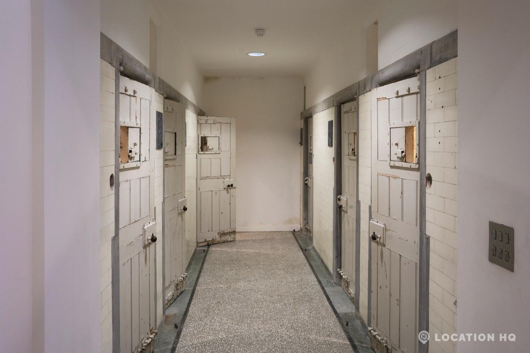 Historic institutional corridor with original cell doors