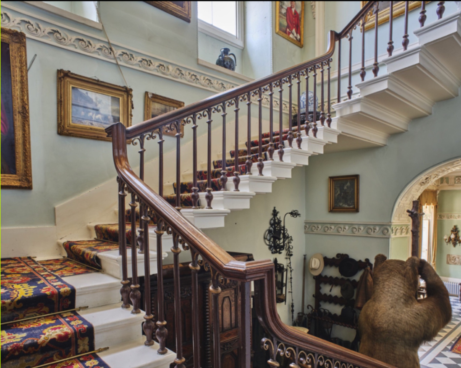 Historic staircase rising from a reception hall