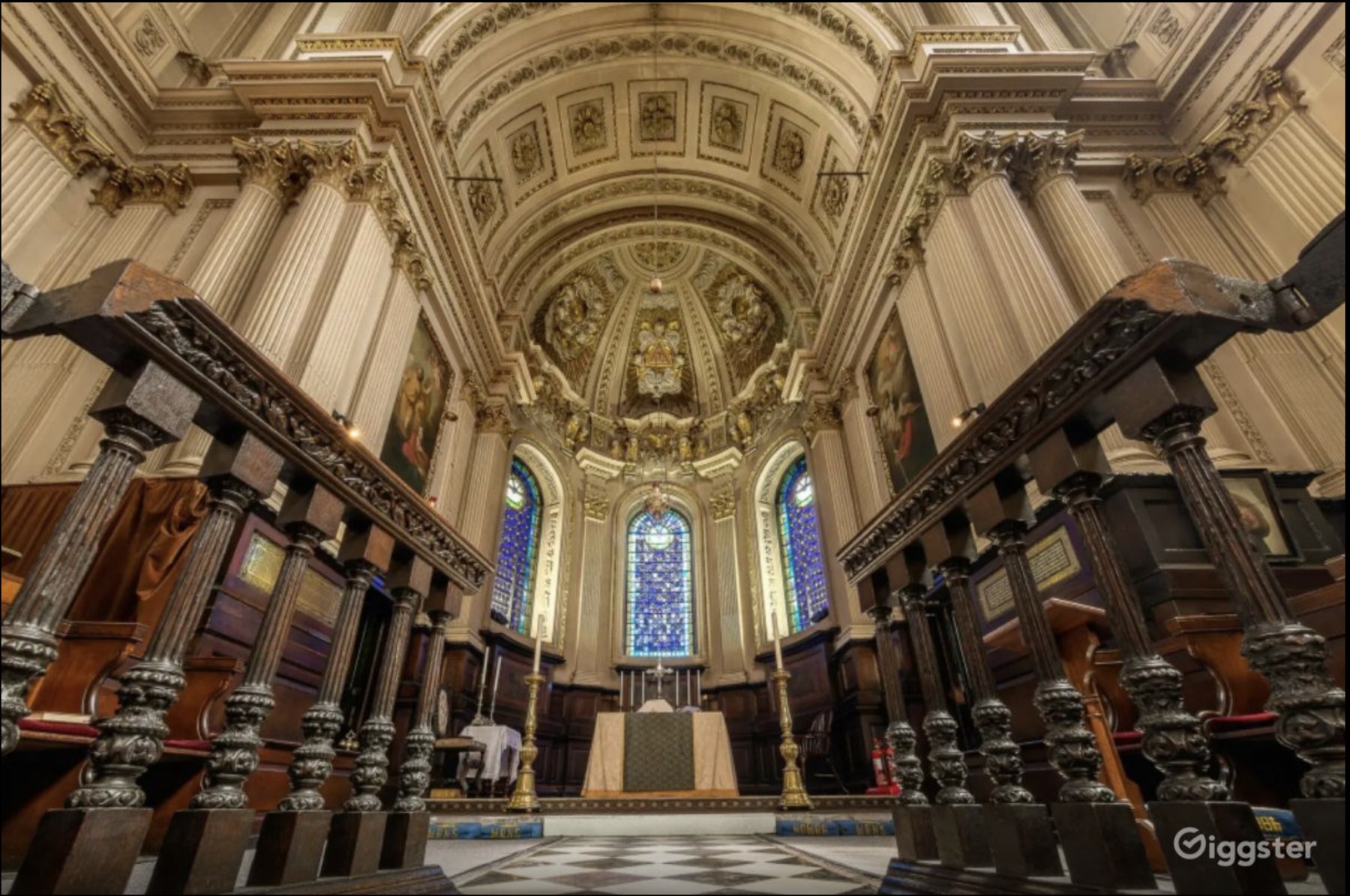 Ornate church interior with stained glass and a vaulted ceiling