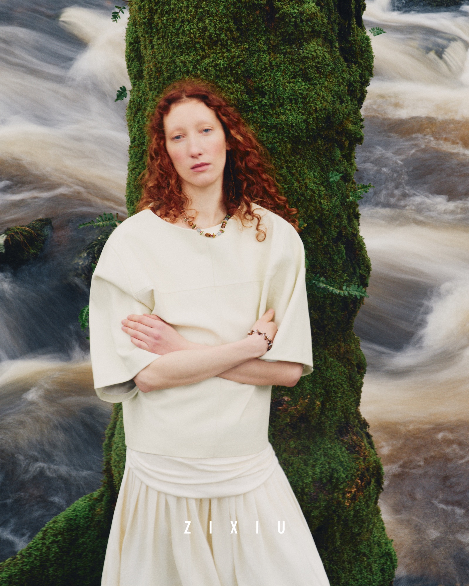 ZIXIU model standing against moss and moving water